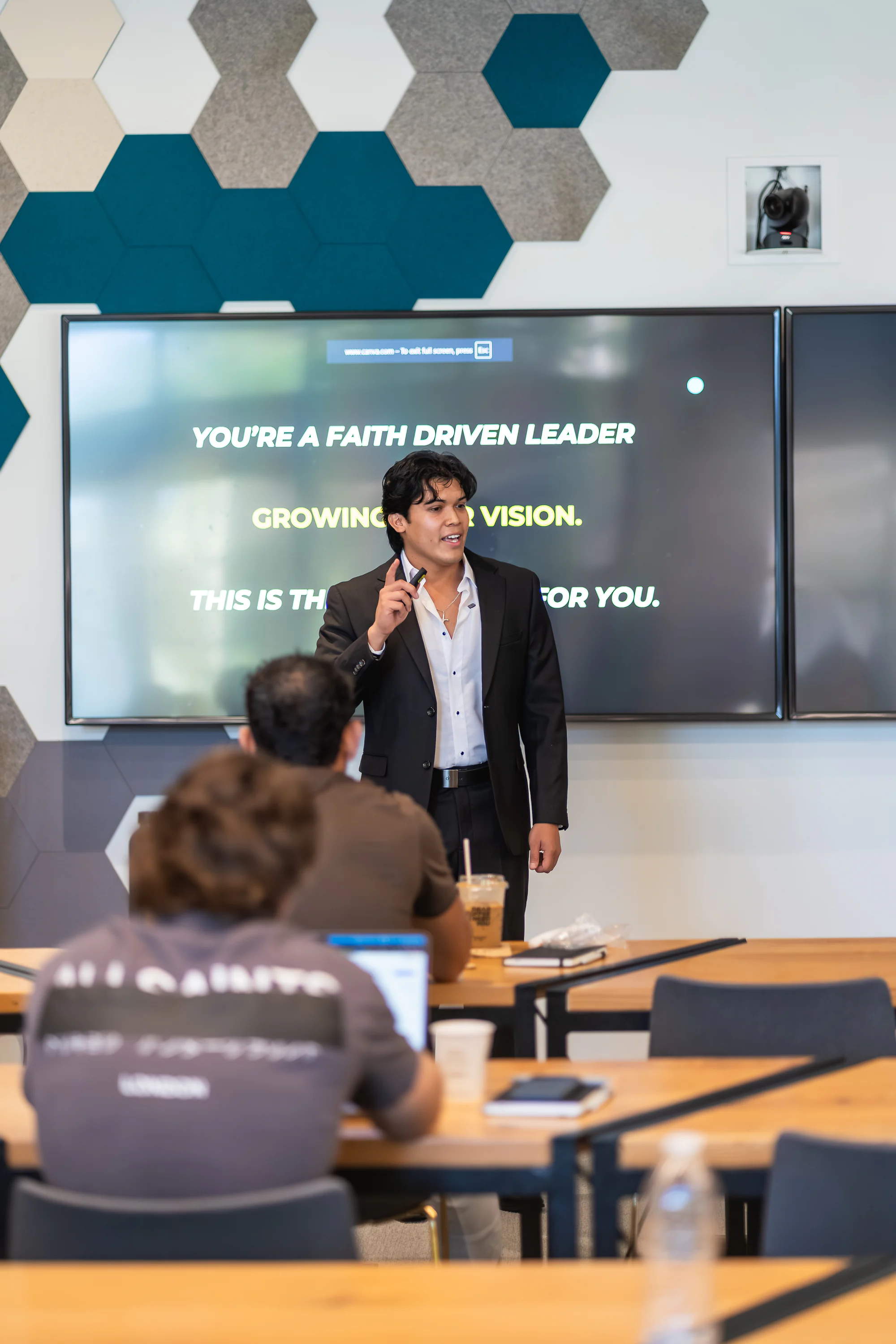 Eliam Fuentes speaking to a room at his Faith Driven Leadership event
