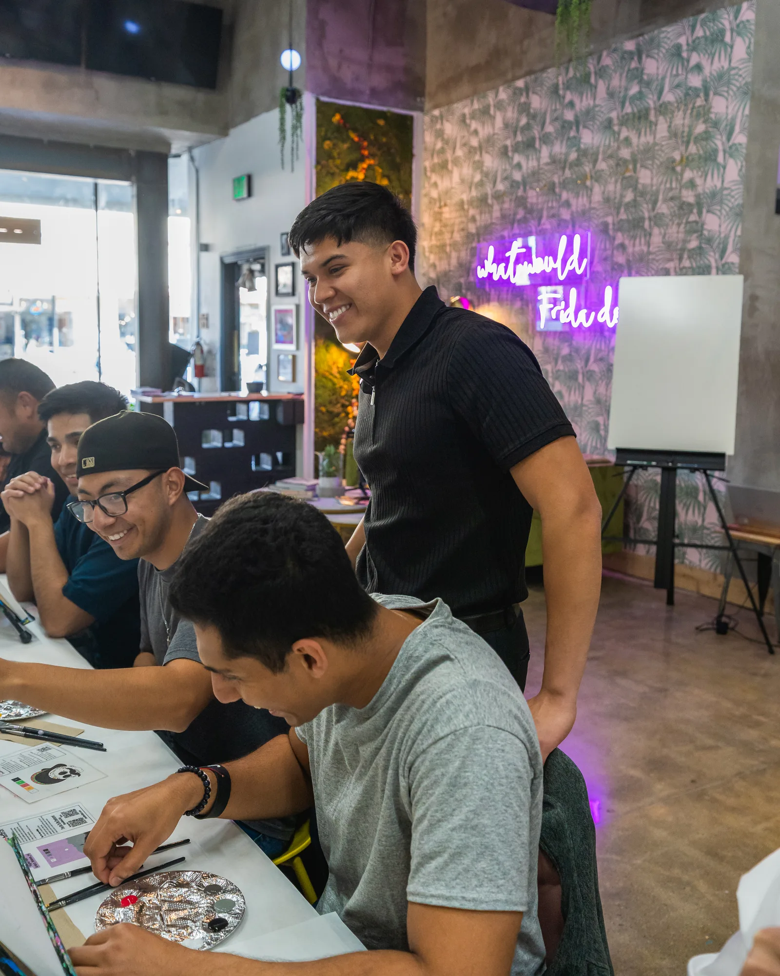 Eliam Fuentes laughing with attendees at his communication workshop
