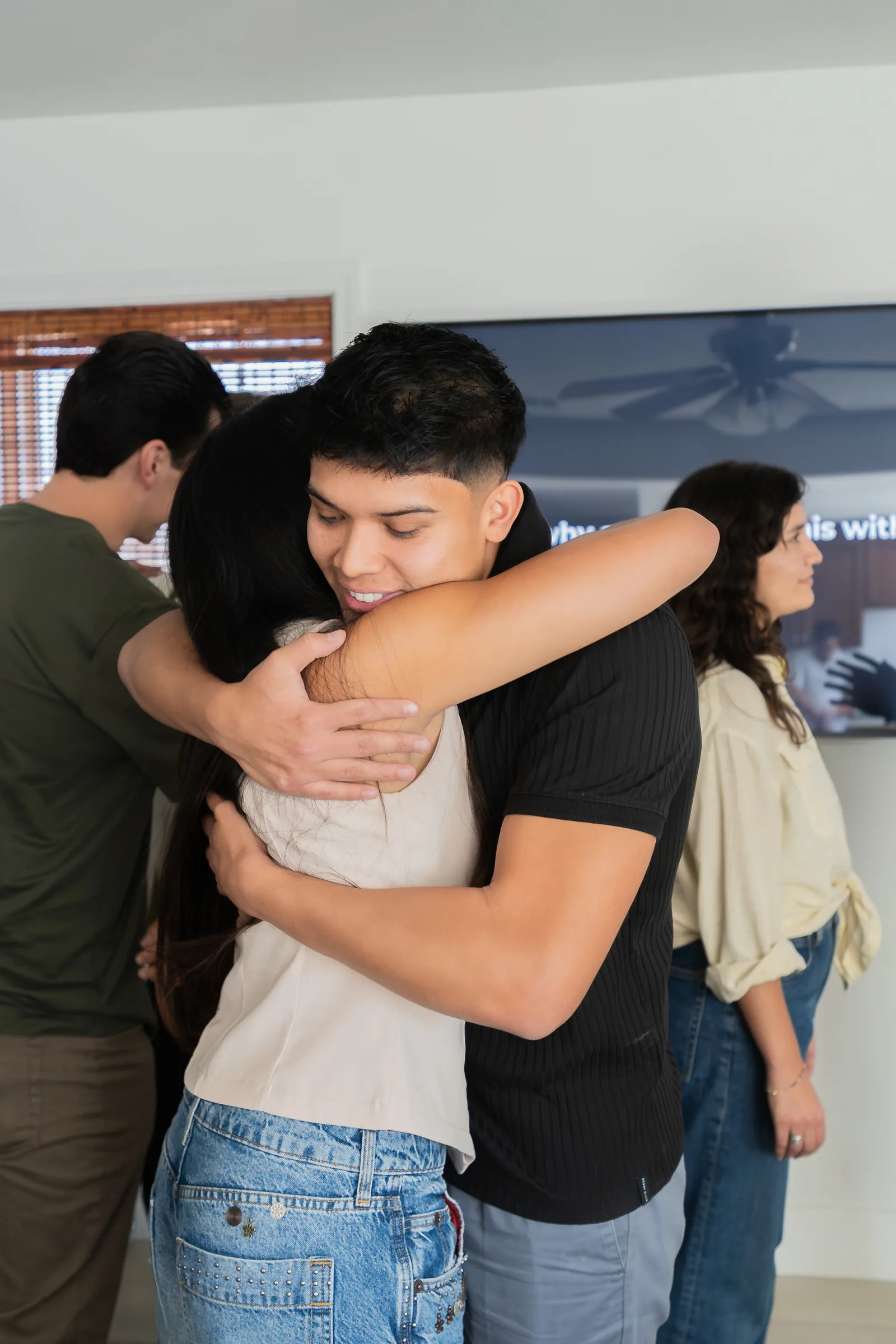 Eliam Fuentes hugging a participant at the MCU Mastermind