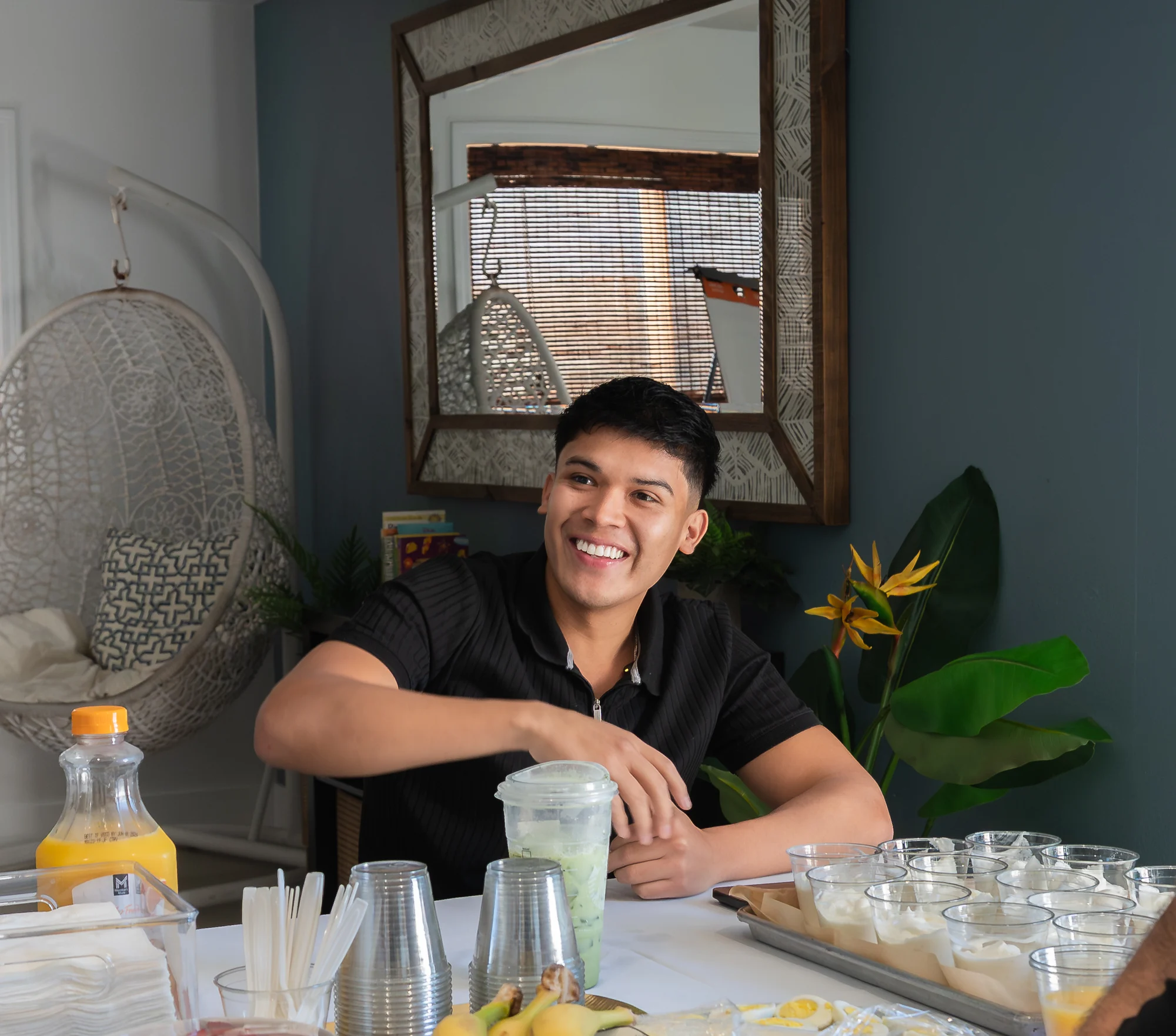 Eliam Fuentes laughing at the breakfast table at the MCU Storyteller's Mastermind